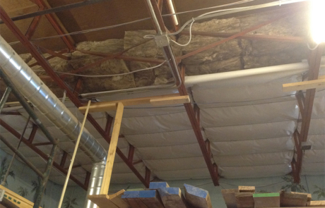 Image of a large warehouse building during the installation of new insulation in central New Mexico
