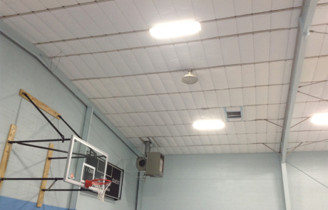 Image of the inside of a gymnasium after the installation of new insulation in central New Mexico