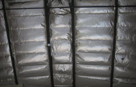 Interior roof of a building after new fiberglass insulation has been installed in central New Mexico