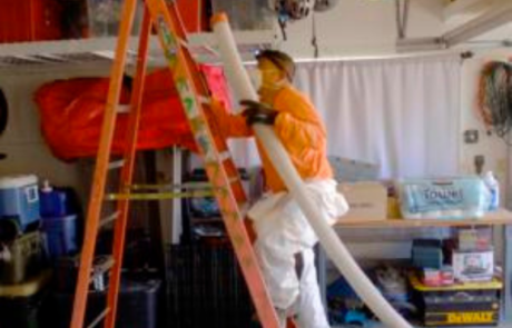 Man going up ladder to insulate in central New Mexico