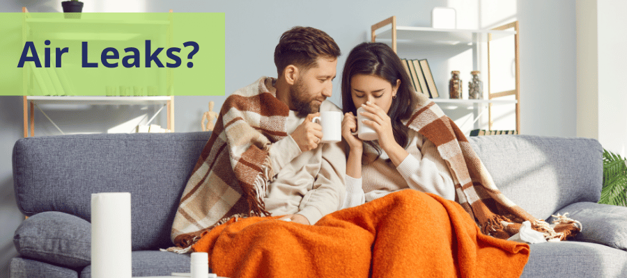 Image of a blanket wrapped couple that may be experiencing air leaks